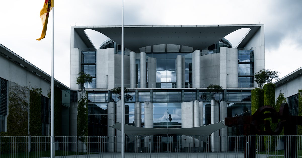 Modern government office building with a national flag