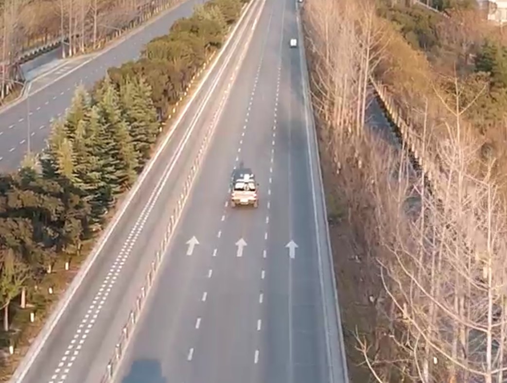 A vehicle carrying a four-faced array radar driving on a highway during an on-the-move detection trial.